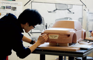 Student Jay Uh works on a clay model