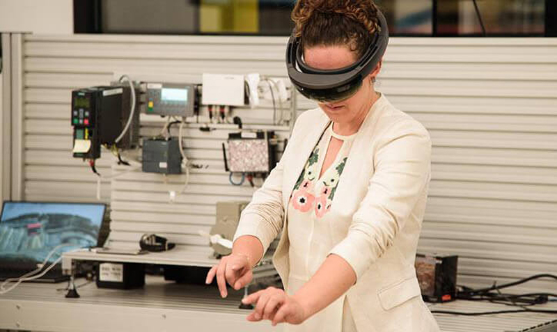 A woman wears a virtual reality headset in the Accenture Detroit Innovation Hub