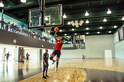 a man shotting a layup on a basketball court