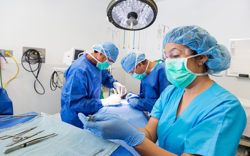 Surgical nurse or technician is prepping instruments for hospital procedure