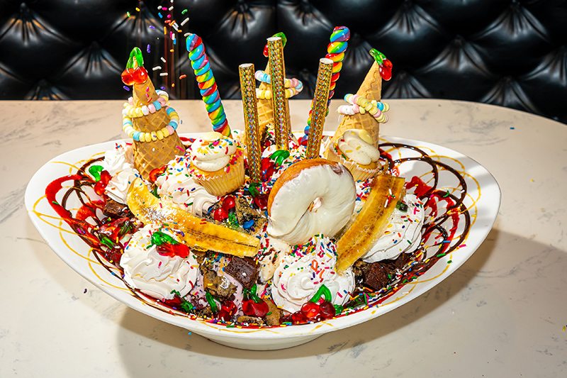 The King Kong Sundae serves up to 12 people with 24 scoops of ice cream covered with sprinkles, gummy bears, caramel sauce, hot fudge sauce and giant whirly pops. // Courtesy of Sugar Factory Detroit