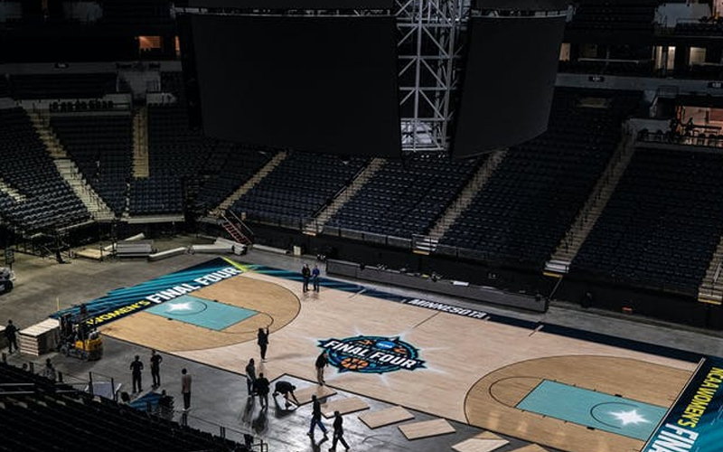 Aerial photo of a team assembling a basketball court's flooring.