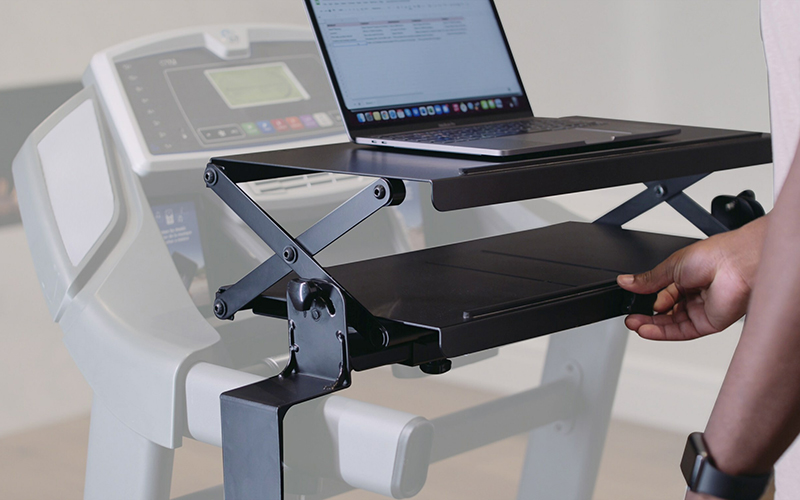 Photo of treadmill with Walk-i-Task attachment, which has a platform with a laptop on it.